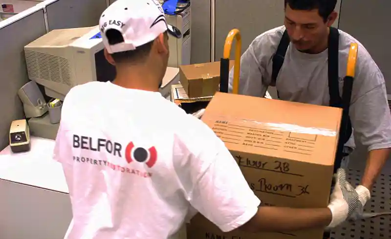 BELFOR technicians remove packed box from office